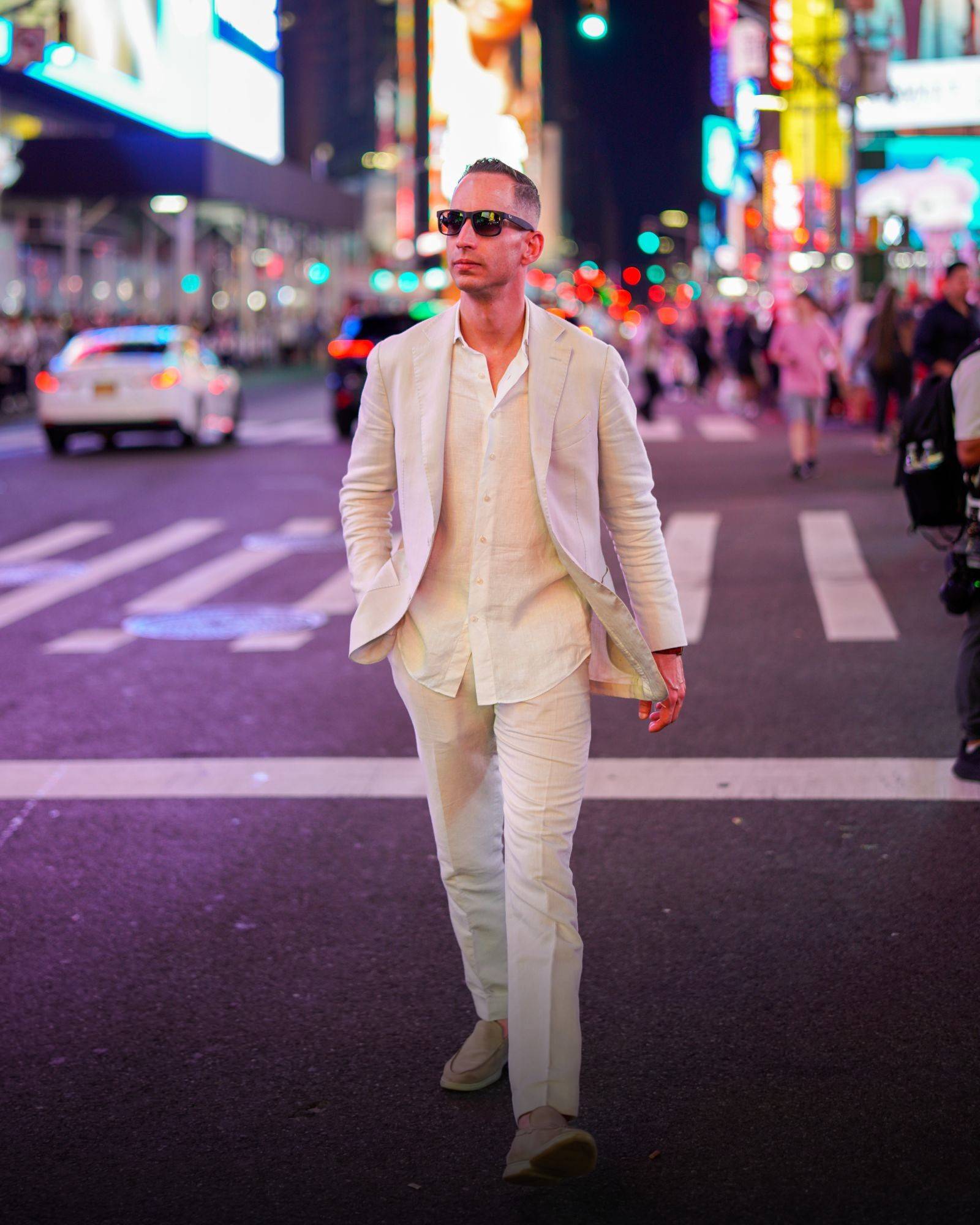 John Silvera crossing Times Square at night